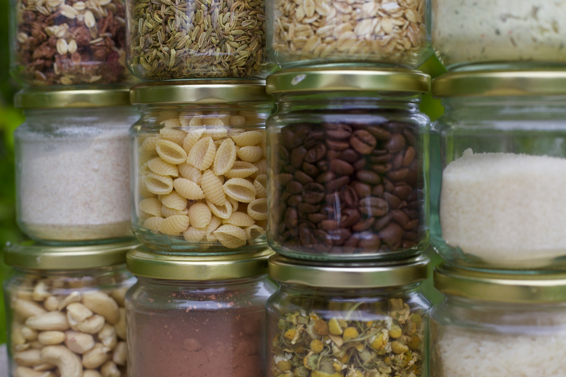 Glass jars filled with rice, pasta, and other pantry staples